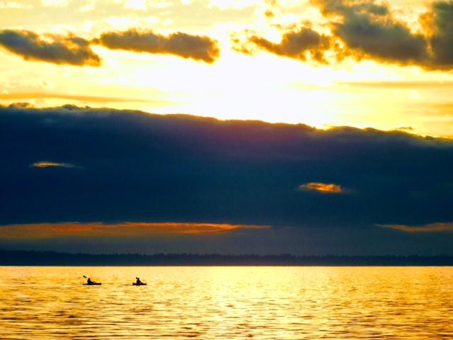 East Beach in White Rock inspires with its beauty. Here: “Chatting With God” a photograph of two kayakers with a lucky cloud formation.
